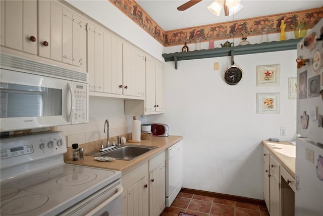 225 E Swissvale Ave Unit 2, Edgewood, PA 15218 - kitchen with white appliances, light countertops, ceiling fan, white cabinets, and dark tile patterned flooring