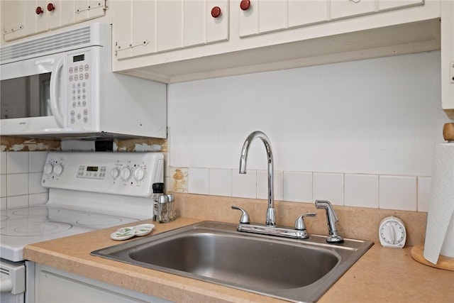 225 E Swissvale Ave Unit 2, Edgewood, PA 15218 - kitchen featuring white appliances, decorative backsplash, light countertops, and white cabinets