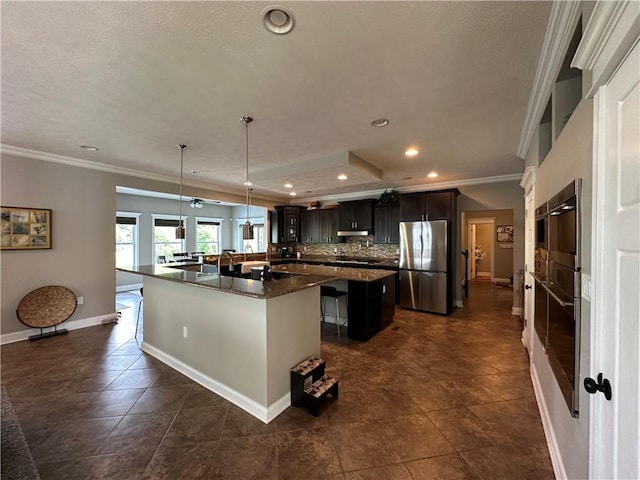 30 Trotter Ln, Findlay Twp, PA 15026 - kitchen with appliances with stainless steel finishes, ornamental molding, a breakfast bar area, a kitchen island, and recessed lighting