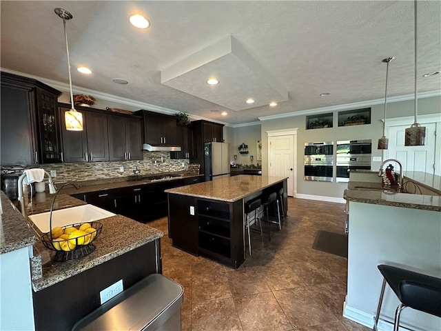 30 Trotter Ln, Findlay Twp, PA 15026 - kitchen with freestanding refrigerator, ornamental molding, a center island, backsplash, and a kitchen bar