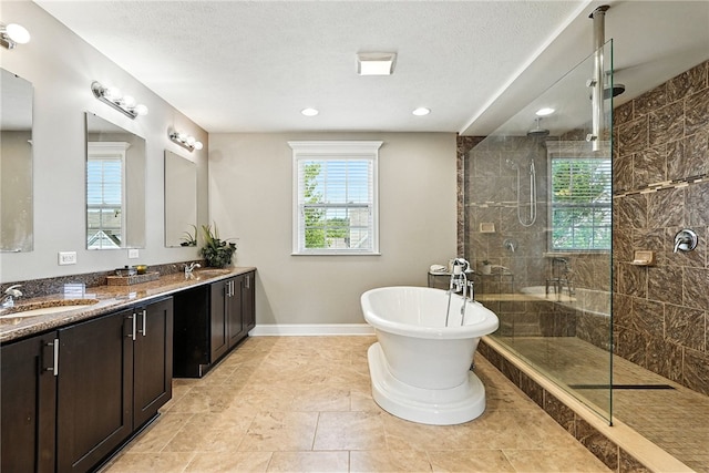 30 Trotter Ln, Findlay Twp, PA 15026 - full bath featuring walk in shower, double vanity, a freestanding bath, recessed lighting, and a textured ceiling