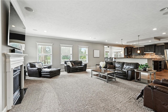 30 Trotter Ln, Findlay Twp, PA 15026 - living room with plenty of natural light, recessed lighting, dark carpet, ornamental molding, and a glass covered fireplace
