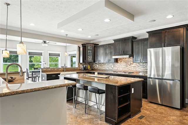 30 Trotter Ln, Findlay Twp, PA 15026 - kitchen with stainless steel appliances, backsplash, ornamental molding, a center island, and light stone counters