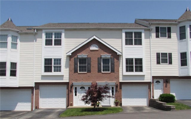 6921 Spring Valley Ln, Murrysville, PA 15632 - multi unit property featuring brick siding, an attached garage, and driveway