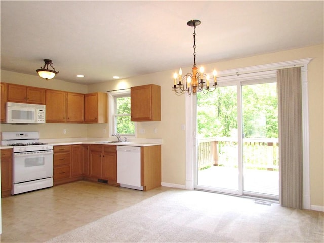 6921 Spring Valley Ln, Murrysville, PA 15632 - kitchen featuring white appliances, light countertops, a chandelier, pendant lighting, and recessed lighting