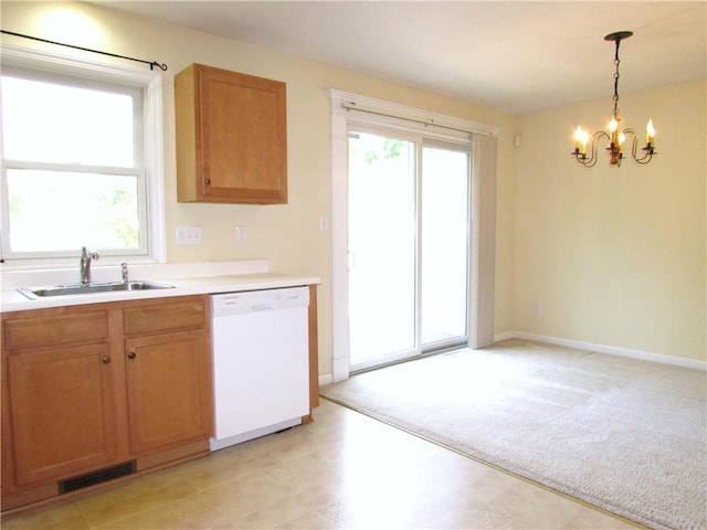6921 Spring Valley Ln, Murrysville, PA 15632 - kitchen featuring white dishwasher, a chandelier, light countertops, pendant lighting, and light carpet