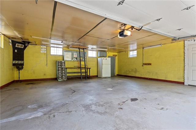 4506 Bowes Ave, West Mifflin, PA 15122 - garage featuring freestanding refrigerator and a garage door opener