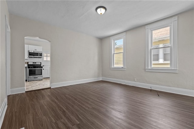4506 Bowes Ave, West Mifflin, PA 15122 - unfurnished living room featuring dark wood finished floors and arched walkways