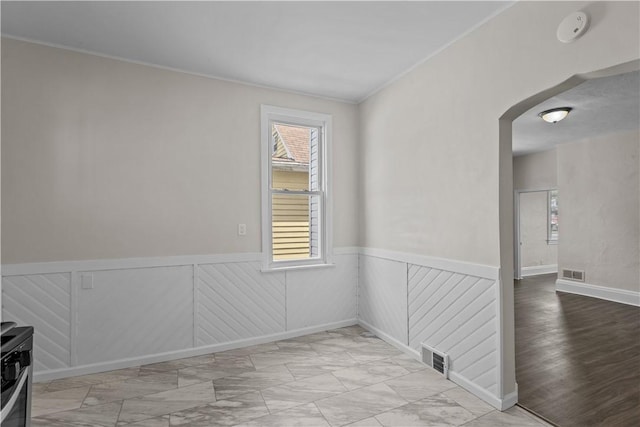 4506 Bowes Ave, West Mifflin, PA 15122 - spare room with arched walkways, light marble finish flooring, a wainscoted wall, ornamental molding, and a smoke detector