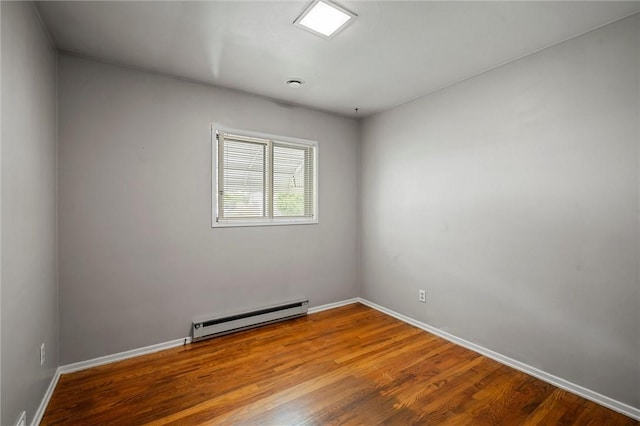 2485 Victoria Dr, Hermitage, PA 16148 - empty room with baseboard heating and wood finished floors