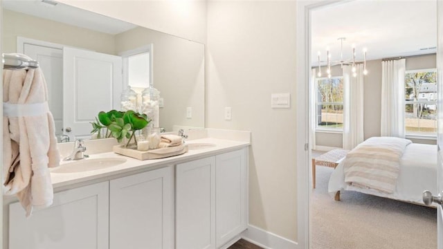 364 Leslie Farms Dr, Connoquenessing Boro, PA 16033 - ensuite bathroom featuring double vanity and a chandelier