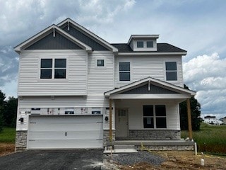 364 Leslie Farms Dr, Connoquenessing Boro, PA 16033 - view of front of property featuring a porch, an attached garage, driveway, and stone siding