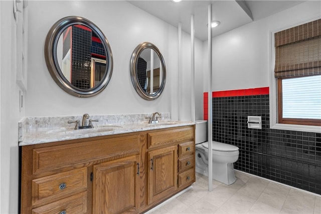 710 Duncan Ave, City Of Washington, PA 15301 - full bath featuring tile walls, tile patterned floors, double vanity, and a wainscoted wall