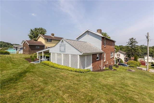 217 Orchard St, West Deer, PA 15006 - back of property with brick siding, a yard, a chimney, and roof with shingles