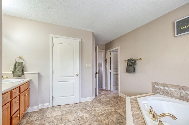 2023 Sterling Dr, South Fayette, PA 15057 - bathroom featuring a garden tub, vanity, and a textured ceiling