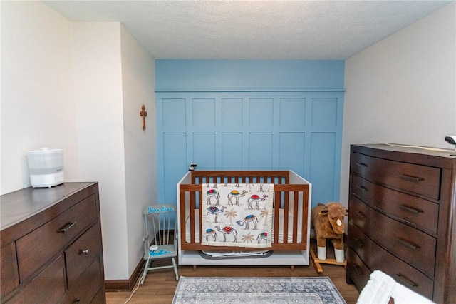 406 Dove Dr, South Union Twp, PA 15401 - bedroom with wood finished floors, a closet, and a textured ceiling