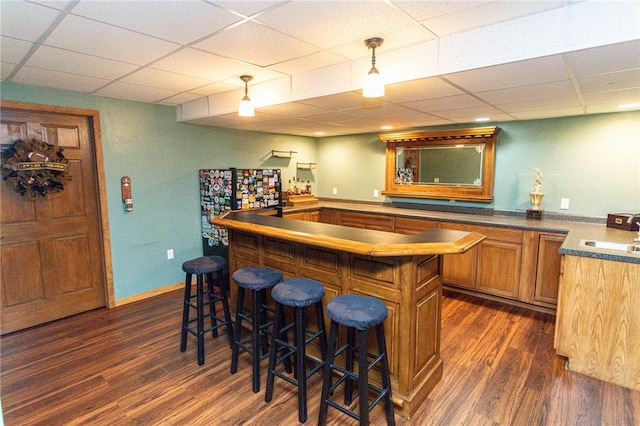 406 Dove Dr, South Union Twp, PA 15401 - indoor dry bar with dark wood-type flooring, a drop ceiling, and hanging light fixtures