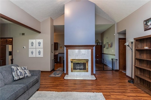 406 Dove Dr, South Union Twp, PA 15401 - living area with wood finished floors, high vaulted ceiling, and a tiled fireplace