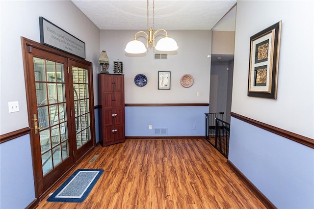 406 Dove Dr, South Union Twp, PA 15401 - dining area with wood finished floors, a chandelier, healthy amount of natural light, and french doors