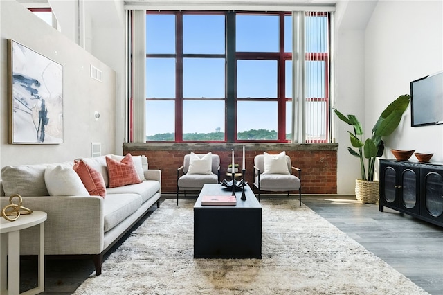 5850 Centre Ave Unit 605, Shadyside, PA 15206 - living area featuring wood finished floors and brick wall