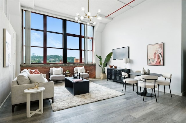 5850 Centre Ave Unit 605, Shadyside, PA 15206 - living area featuring wood finished floors, a chandelier, and vaulted ceiling