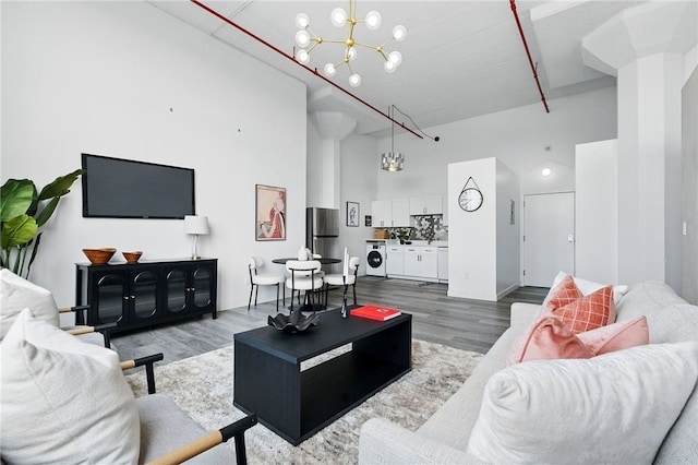 5850 Centre Ave Unit 605, Shadyside, PA 15206 - living room with a towering ceiling, wood finished floors, and a chandelier