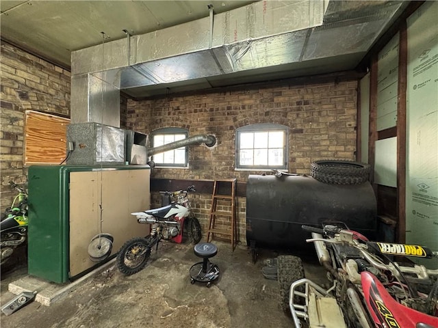 203 10th, St, PA 15963 - miscellaneous room featuring oil tank, unfinished concrete floors, and brick wall