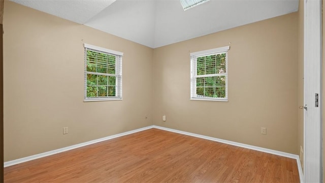 103 Cambridge Ct, Springdale Twp, PA 15049 - spare room with light wood-style flooring, healthy amount of natural light, and vaulted ceiling