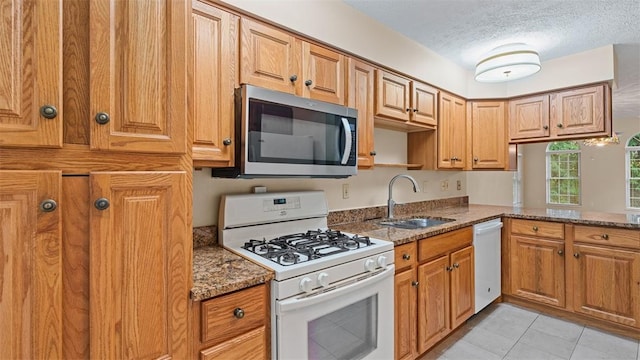 103 Cambridge Ct, Springdale Twp, PA 15049 - kitchen featuring white appliances, stone counters, a textured ceiling, and light tile patterned floors
