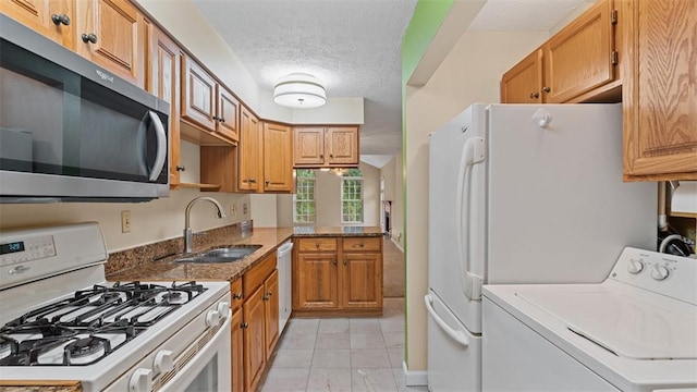 103 Cambridge Ct, Springdale Twp, PA 15049 - kitchen with white appliances, washer / clothes dryer, a textured ceiling, stone counters, and brown cabinets