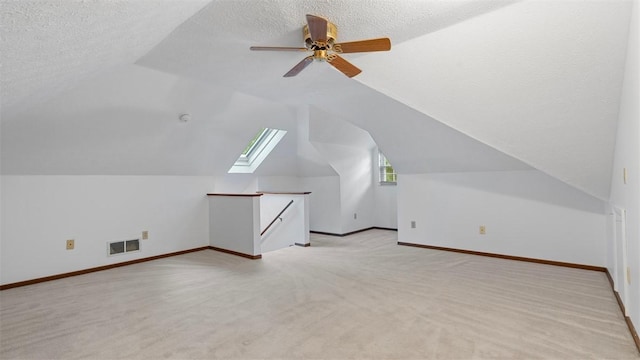 103 Cambridge Ct, Springdale Twp, PA 15049 - additional living space with vaulted ceiling, light colored carpet, a textured ceiling, a skylight, and ceiling fan