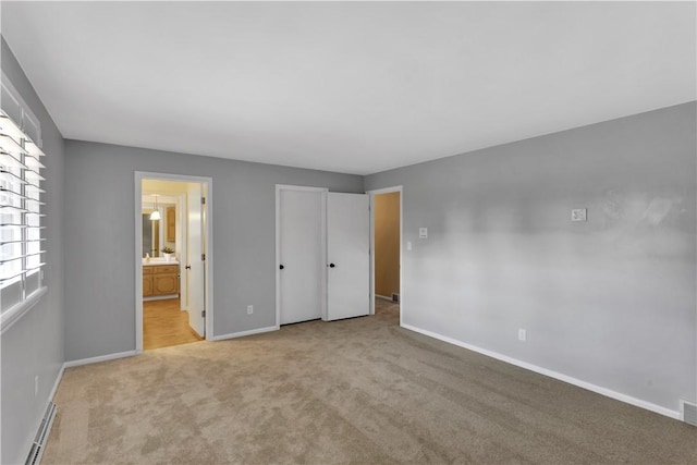 425 Ridge Rd, Hempfield Twp Wml, PA 15601 - unfurnished bedroom featuring carpet, baseboard heating, and connected bathroom