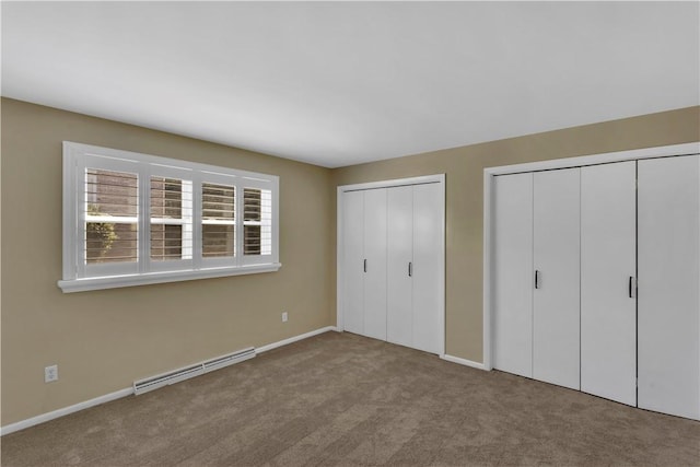 425 Ridge Rd, Hempfield Twp Wml, PA 15601 - unfurnished bedroom with baseboard heating, two closets, and carpet floors