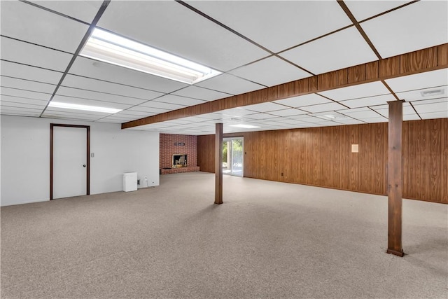 425 Ridge Rd, Hempfield Twp Wml, PA 15601 - below grade area featuring wood walls, a fireplace, carpet, and a drop ceiling