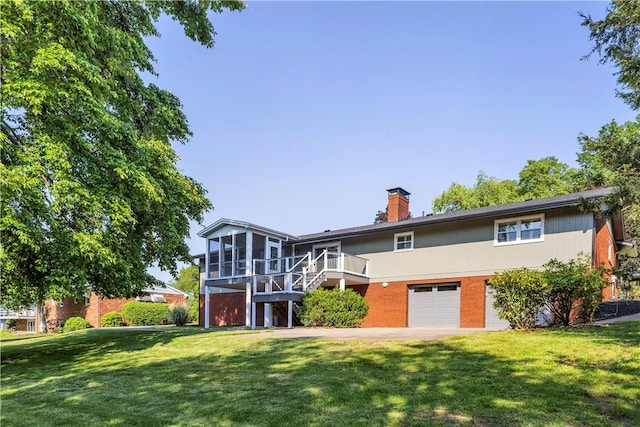 425 Ridge Rd, Hempfield Twp Wml, PA 15601 - back of property featuring a sunroom, an attached garage, brick siding, stairway, and a chimney