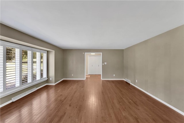 425 Ridge Rd, Hempfield Twp Wml, PA 15601 - empty room with a baseboard radiator and wood finished floors