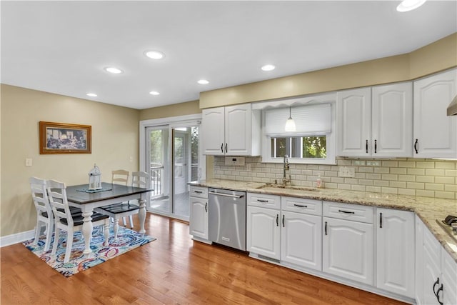 425 Ridge Rd, Hempfield Twp Wml, PA 15601 - kitchen with stainless steel dishwasher, light wood-type flooring, backsplash, light stone countertops, and recessed lighting