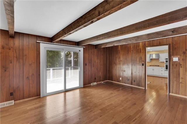425 Ridge Rd, Hempfield Twp Wml, PA 15601 - empty room with beam ceiling, wood-type flooring, and wood walls