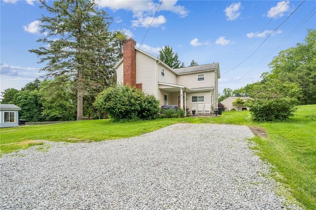 215-217 Fairlawn Dr, Monroeville, PA 15146 - view of front of property featuring a chimney, gravel driveway, and a front lawn