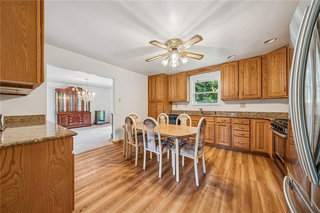 215-217 Fairlawn Dr, Monroeville, PA 15146 - dining room featuring light wood-type flooring, a chandelier, and a ceiling fan