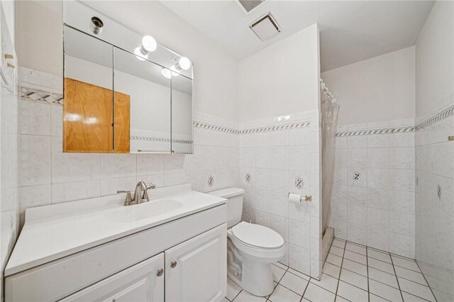 215-217 Fairlawn Dr, Monroeville, PA 15146 - bathroom featuring tile walls, tile patterned flooring, vanity, and a tile shower