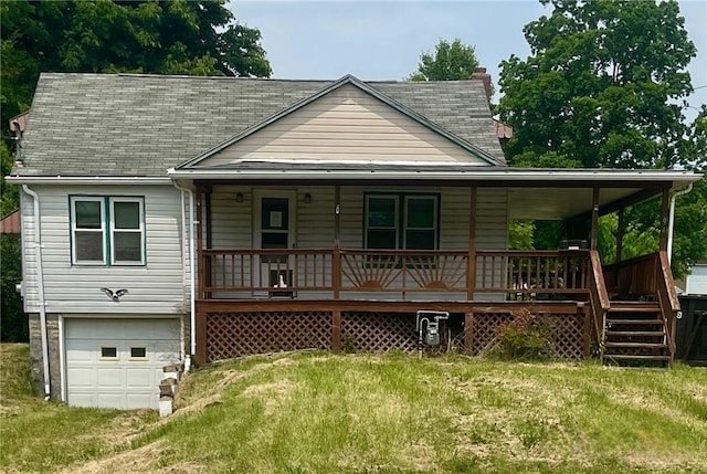594 E Main St, Pine Twp Mer, PA 16127 - view of front facade featuring an attached garage, a porch, a shingled roof, and a front lawn