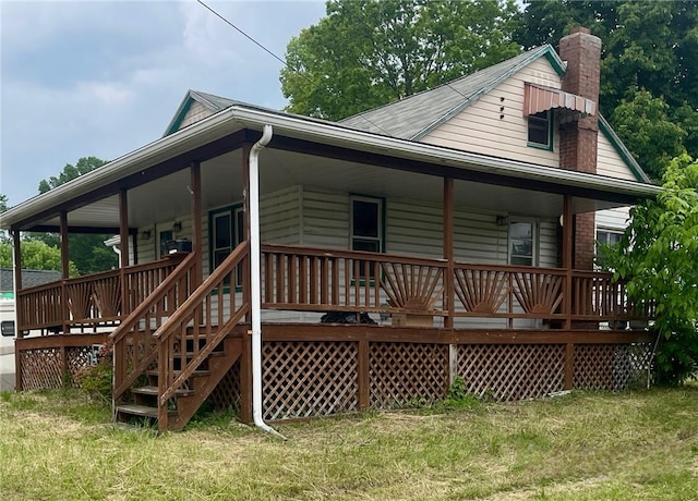 594 E Main St, Pine Twp Mer, PA 16127 - rear view of property featuring a lawn, a chimney, and covered porch