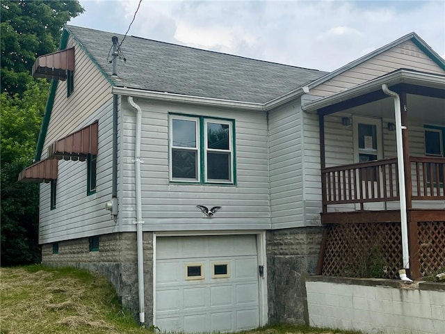 594 E Main St, Pine Twp Mer, PA 16127 - view of side of home with a garage, roof with shingles, and covered porch