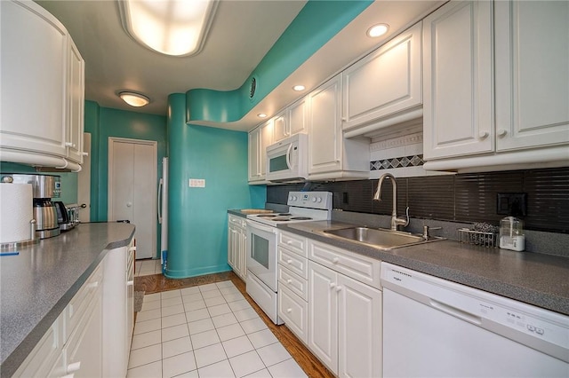 320 Fort Duquesne Blvd Unit 26N, Downtown Pgh, PA 15222 - kitchen with white appliances, dark countertops, white cabinets, and tasteful backsplash