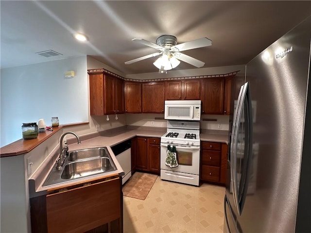 207 Village Ct, South Strabane, PA 15301 - kitchen with white appliances, ceiling fan, light countertops, and light floors