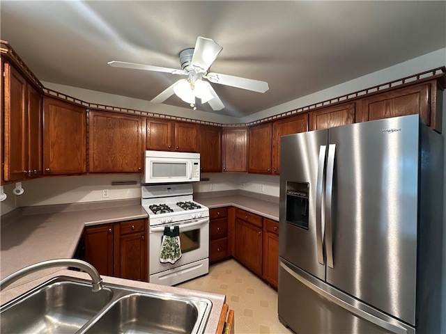 207 Village Ct, South Strabane, PA 15301 - kitchen featuring white appliances, light countertops, a ceiling fan, and light flooring