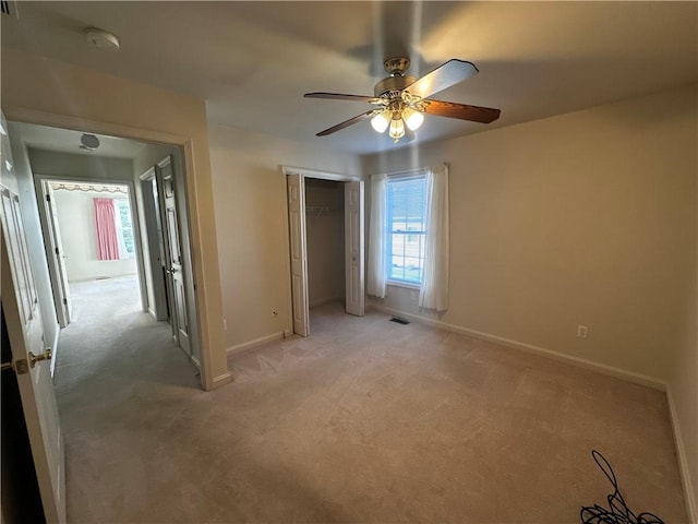 207 Village Ct, South Strabane, PA 15301 - unfurnished bedroom featuring light colored carpet, a closet, and a ceiling fan