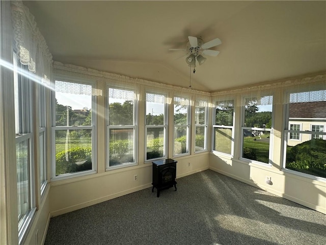 207 Village Ct, South Strabane, PA 15301 - unfurnished sunroom featuring lofted ceiling, a wood stove, healthy amount of natural light, and carpet flooring