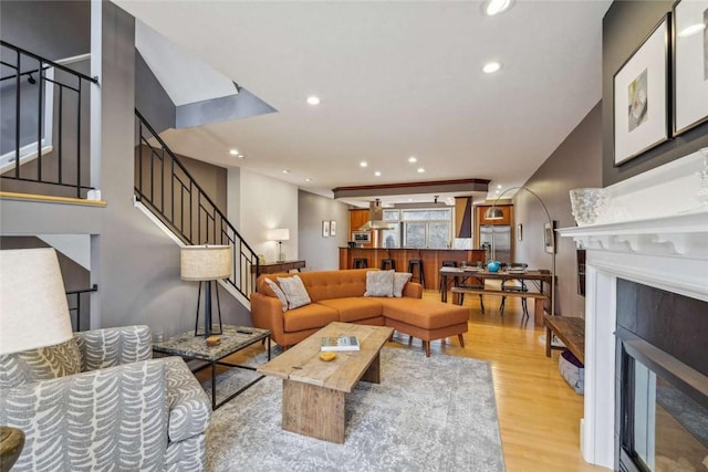 71 Waterfront Dr, Washingtons Landing, PA 15222 - living room with a glass covered fireplace, light wood finished floors, stairway, and recessed lighting